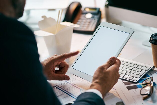 A person using a tablet to access government website for tax benefits, surrounded by documents and a calculator, illustrating the process of applying for tax benefits online.
