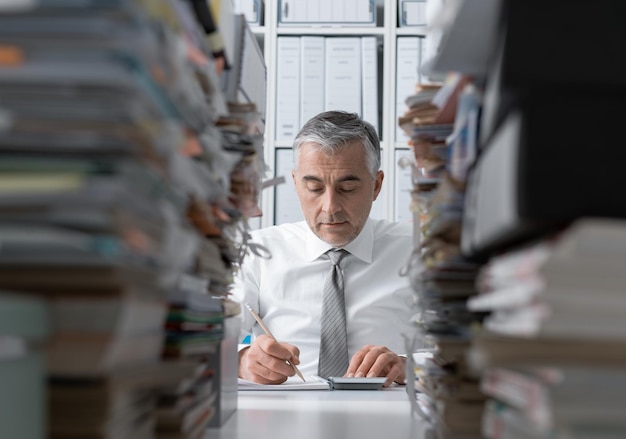 A person carefully organizing financial documents and receipts in a filing cabinet, symbolizing meticulous record-keeping for tax purposes.