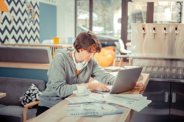 A student studying at a desk with textbooks and a laptop, with a financial chart overlaid subtly to represent the financial planning aspect of claiming tax credits.