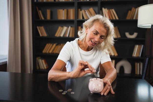 A person putting money into a piggy bank shaped like a retirement home, symbolizing saving for retirement and the benefits of the saver's credit.