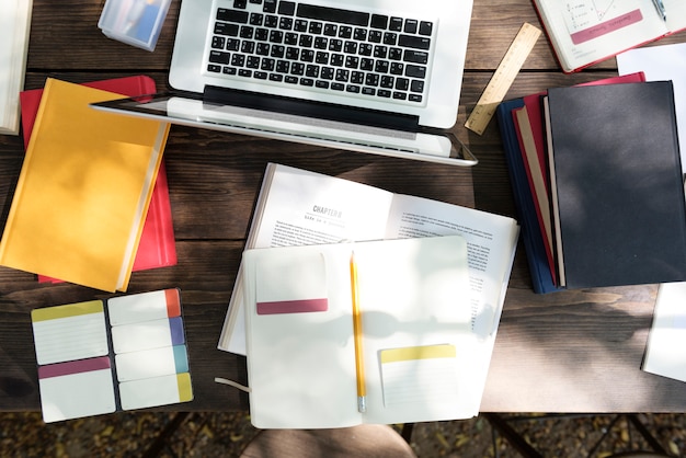 A close-up image of various academic documents and transcripts being organized on a desk, with a hand reaching for a pen, symbolizing the preparation for degree validation. The scene is well-lit and professional.