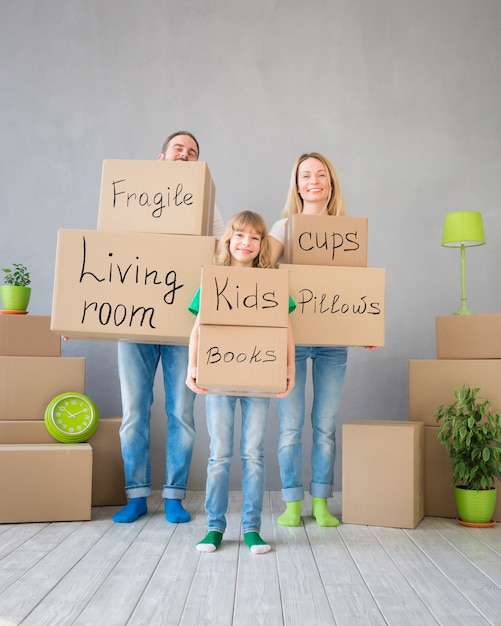 A split image showing a happy family moving into a new home on one side, and a concerned individual looking at a mortgage statement on the other side, symbolizing the varying impacts of interest rate hikes.